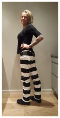 woman-motorcycle-leather-trouser-prisoner-striped-jail-hold-fast-back