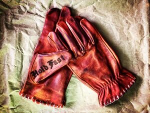 Red Hold Fast Boardtrack gloves in patinated leather, viewed from above