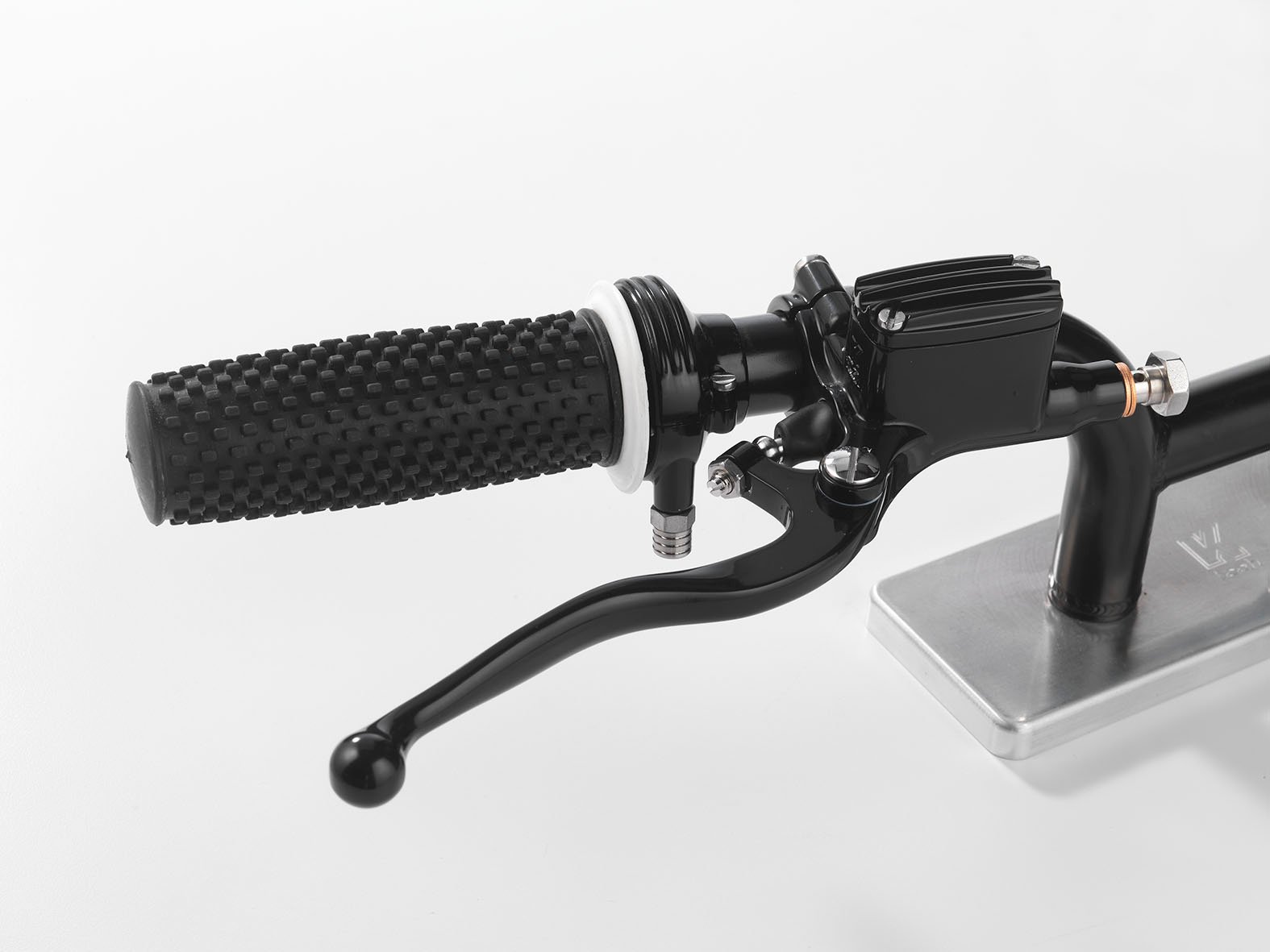 KustomTech master cylinder black anodised 14 mm bore Brake master cylinder KustomTech black anodised billet-machined metal detail of threads and fixings for a custom motorcycle